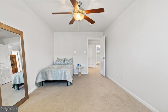 bedroom with baseboards, ceiling fan, and light carpet