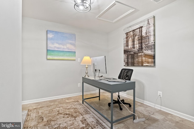 home office featuring baseboards and attic access