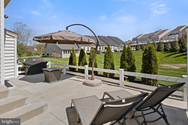 view of patio featuring a residential view and a grill