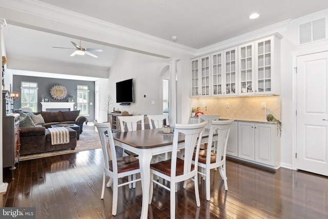 dining space with a ceiling fan, visible vents, dark wood finished floors, ornamental molding, and recessed lighting