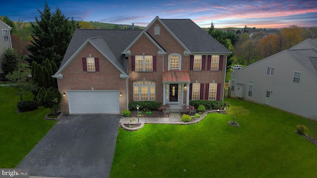 6420 Barrington Dr, Frederick, MD 21701 - view of front facade with a front yard, brick siding, driveway, and an attached garage