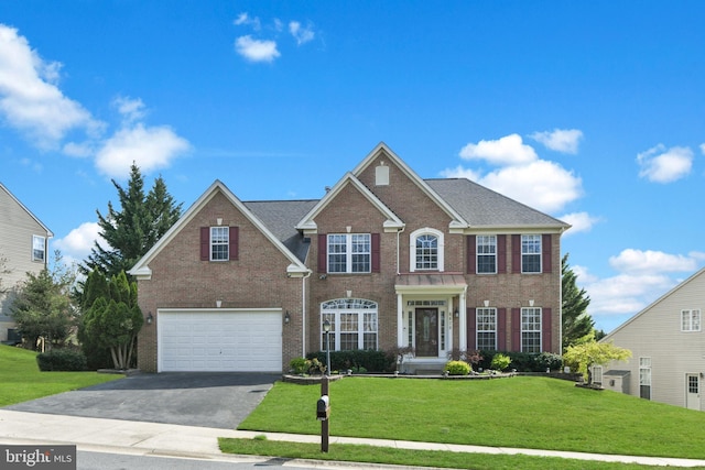 6420 Barrington Dr, Frederick, MD 21701 - view of front facade with aphalt driveway, roof with shingles, a front lawn, brick siding, and an attached garage