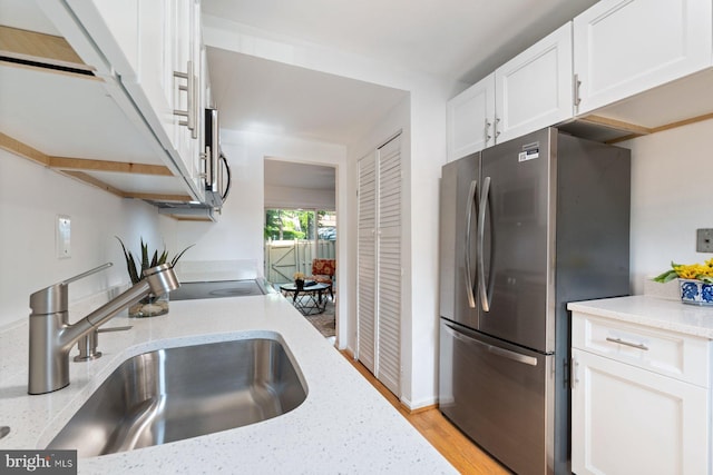 14311 Astrodome Dr Unit 6, Silver Spring, MD 20906 - kitchen featuring appliances with stainless steel finishes, a sink, white cabinetry, and light stone countertops