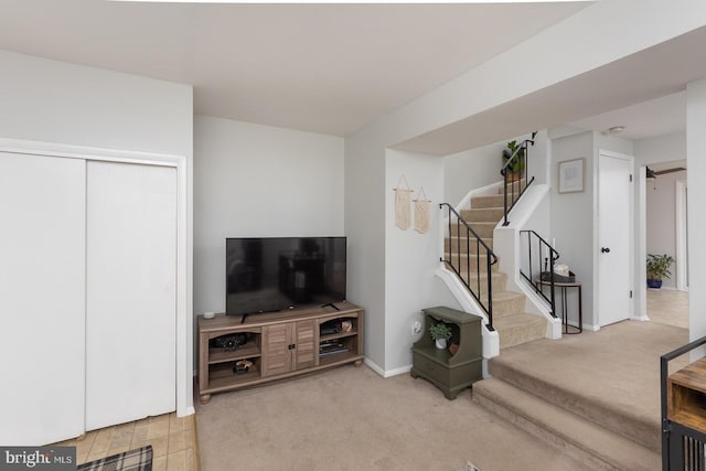 unfurnished living room with baseboards, stairs, and carpet flooring