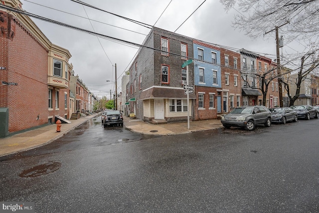 exterior space featuring curbs, street lights, and sidewalks