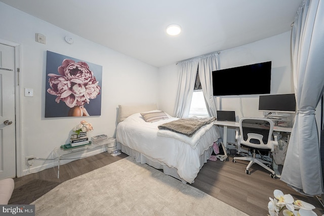 bedroom with wood finished floors