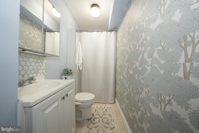 full bathroom with toilet, tile patterned floors, and vanity