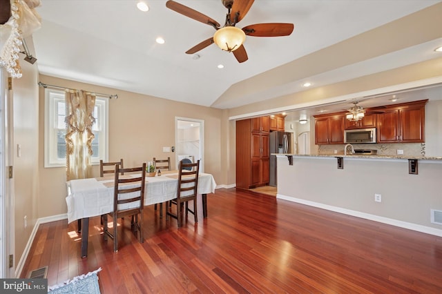 dining room featuring dark wood-style flooring, visible vents, recessed lighting, lofted ceiling, and a ceiling fan