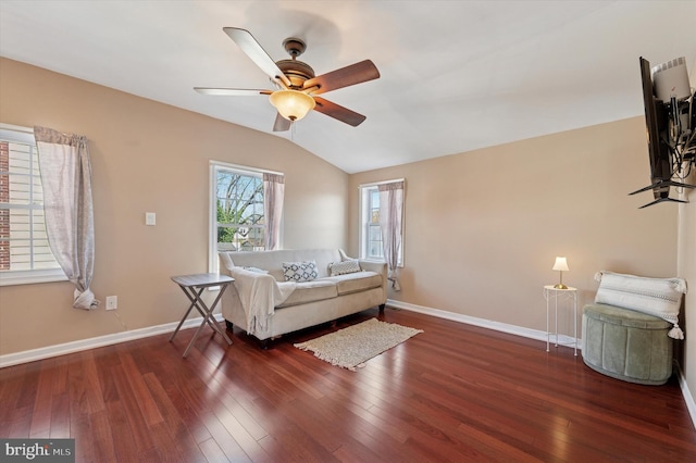 living room featuring vaulted ceiling, a ceiling fan, and wood finished floors