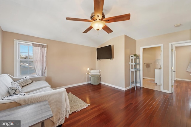 living area with vaulted ceiling, hardwood / wood-style floors, baseboards, and ceiling fan