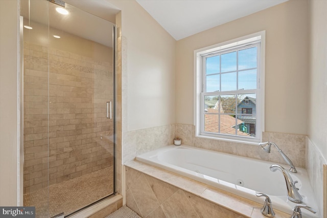full bath featuring a bath and a shower stall