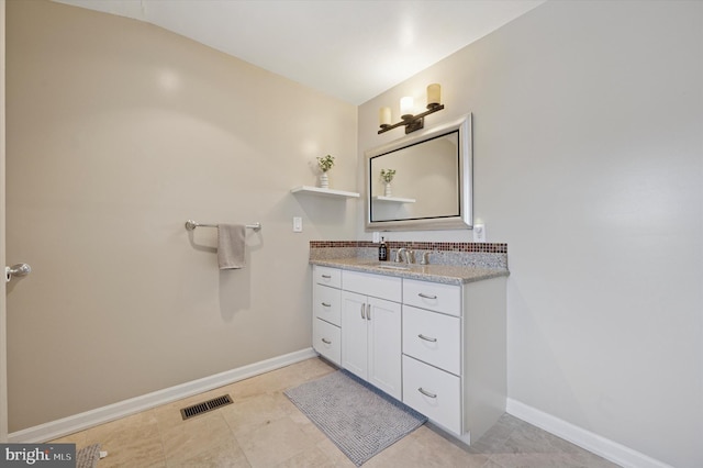 bathroom with baseboards, visible vents, tile patterned flooring, and vanity