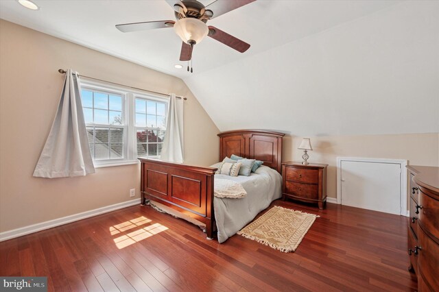 bedroom featuring vaulted ceiling, a ceiling fan, wood finished floors, and baseboards