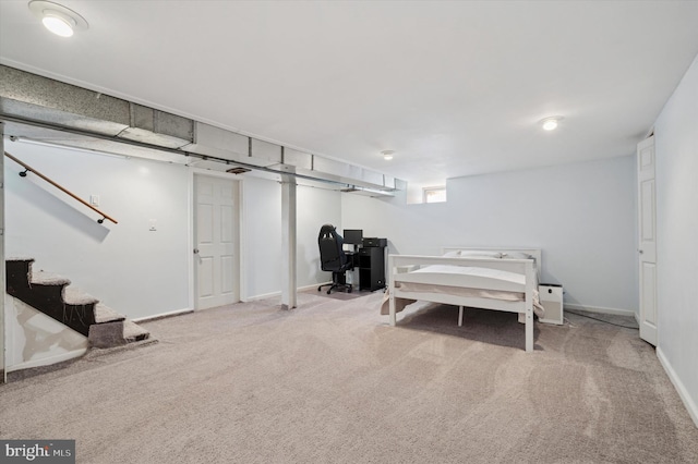 basement featuring baseboards, stairs, and carpet