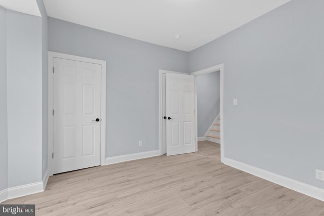 unfurnished bedroom featuring baseboards and light wood-style floors