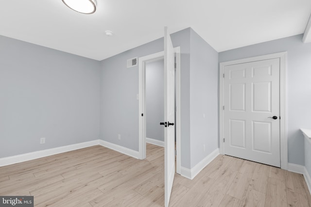 interior space with visible vents, light wood-style flooring, and baseboards