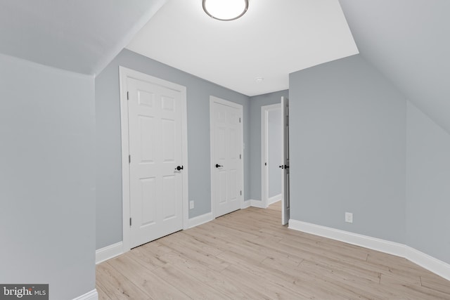 bonus room with baseboards, wood finished floors, and lofted ceiling