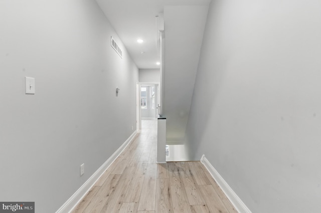 hallway featuring recessed lighting, visible vents, light wood-type flooring, and baseboards