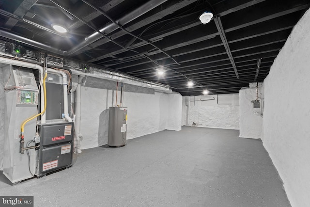 basement featuring electric water heater and heating unit