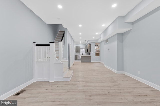 corridor with visible vents, recessed lighting, and light wood-style floors