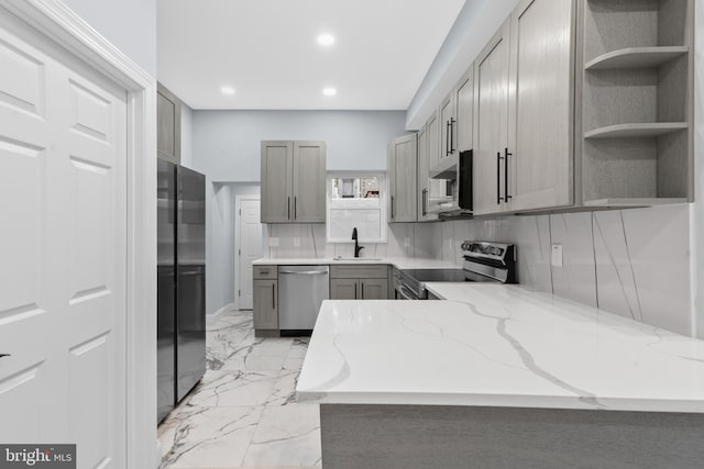 kitchen featuring gray cabinets, marble finish floor, a sink, and appliances with stainless steel finishes