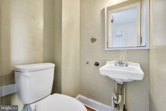 half bathroom featuring toilet