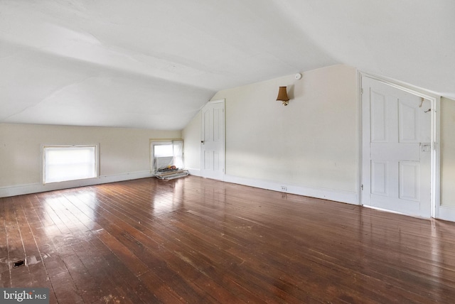 additional living space featuring baseboards, hardwood / wood-style floors, and lofted ceiling