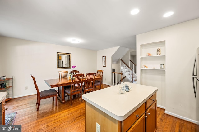 2410 Mallard Ln, Downingtown, PA 19335 - kitchen featuring light countertops, light wood-type flooring, a kitchen island, and baseboards