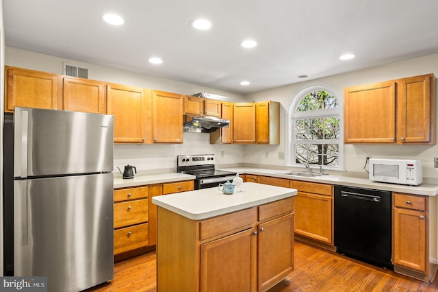 2410 Mallard Ln, Downingtown, PA 19335 - kitchen with under cabinet range hood, stainless steel appliances, wood finished floors, visible vents, and a sink