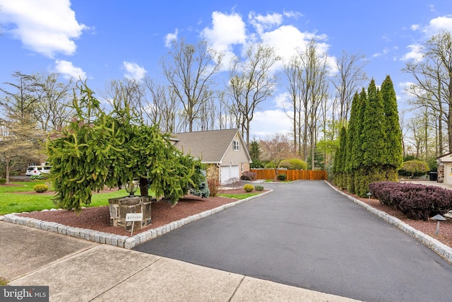 1419 Greenawalt Rd, Huntingdon Valley, PA 19006 - view of side of property with a garage, aphalt driveway, and fence