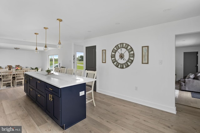 11 Bridge Rd, Lumberton, NJ 08048 - kitchen featuring light wood-style flooring, open floor plan, light countertops, a kitchen island, and a breakfast bar area