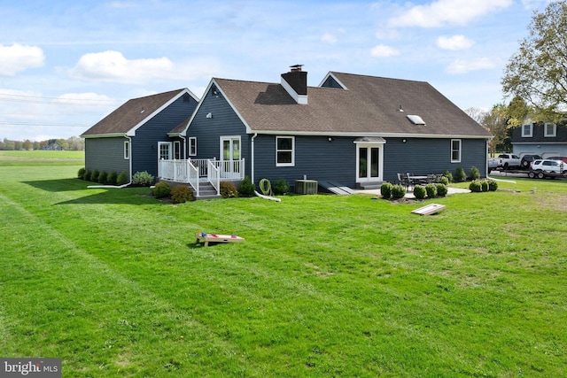 11 Bridge Rd, Lumberton, NJ 08048 - back of property featuring a shingled roof, a chimney, a yard, and cooling unit