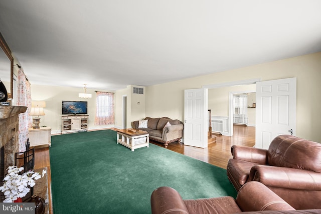 living room with visible vents and wood finished floors