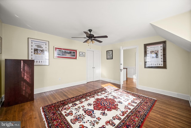 interior space featuring baseboards, ceiling fan, and wood finished floors