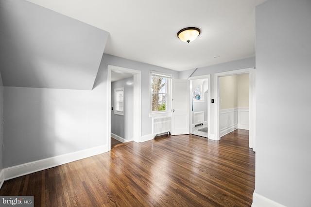 entryway featuring baseboards, wood finished floors, and radiator