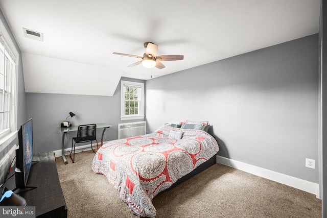bedroom with a ceiling fan, visible vents, baseboards, radiator heating unit, and carpet flooring