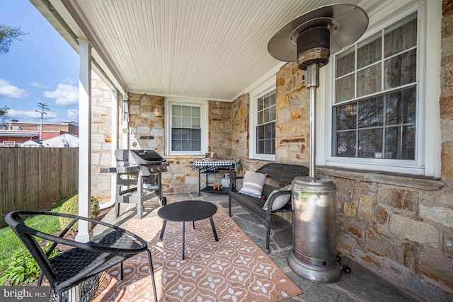 view of patio / terrace with area for grilling and fence