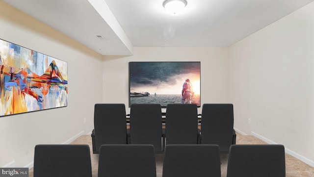 home theater room featuring baseboards and carpet
