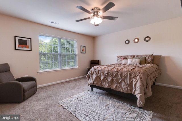carpeted bedroom with visible vents, baseboards, and ceiling fan