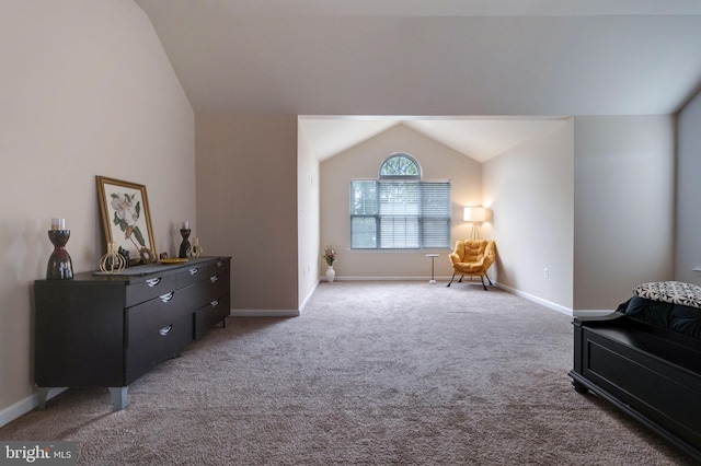 living area with baseboards, light carpet, and vaulted ceiling