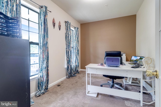 carpeted home office with baseboards and visible vents