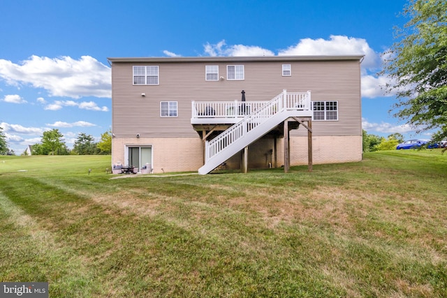 back of property featuring stairs, a wooden deck, a yard, and brick siding
