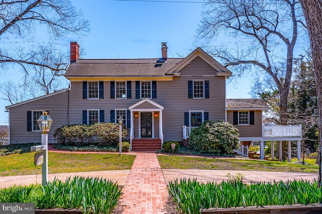 391 Steamboat Rd, Irvington, VA 22480 - colonial house featuring a chimney and a front lawn
