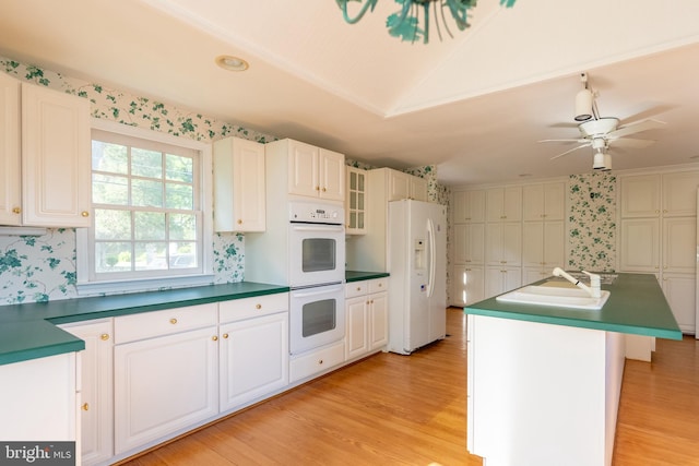 391 Steamboat Rd, Irvington, VA 22480 - kitchen featuring light wood-type flooring, wallpapered walls, a sink, and white appliances