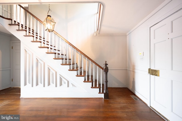391 Steamboat Rd, Irvington, VA 22480 - stairs featuring wood finished floors, ornamental molding, and visible vents