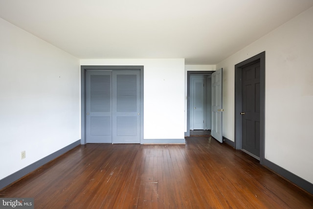 391 Steamboat Rd, Irvington, VA 22480 - unfurnished bedroom featuring a closet, dark wood-type flooring, and baseboards