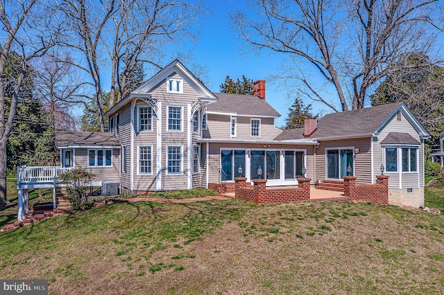391 Steamboat Rd, Irvington, VA 22480 - back of property featuring a sunroom, a yard, a chimney, cooling unit, and a wooden deck