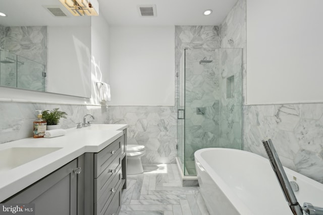 1831 5th St NW, Washington, DC 20001 - bathroom with double vanity, tile walls, marble finish floor, a marble finish shower, and recessed lighting