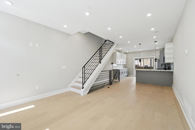 interior space with visible vents, baseboards, recessed lighting, and wood finished floors