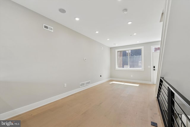 unfurnished room with visible vents, baseboards, recessed lighting, and light wood-style floors